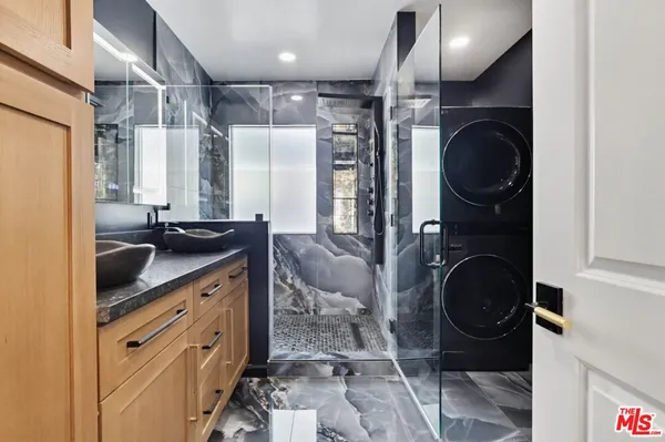 a bathroom with a sink a toilet and a shower