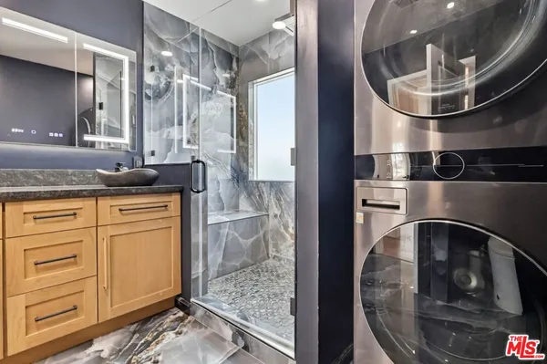 a bathroom with a granite countertop sink a vanity and a mirror