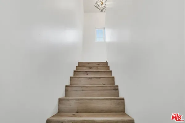 a view of a bedroom with wooden floor