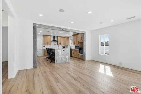 a view of kitchen with cabinets and wooden floor