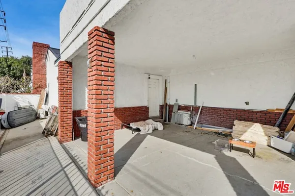 a front view of a house with outdoor seating