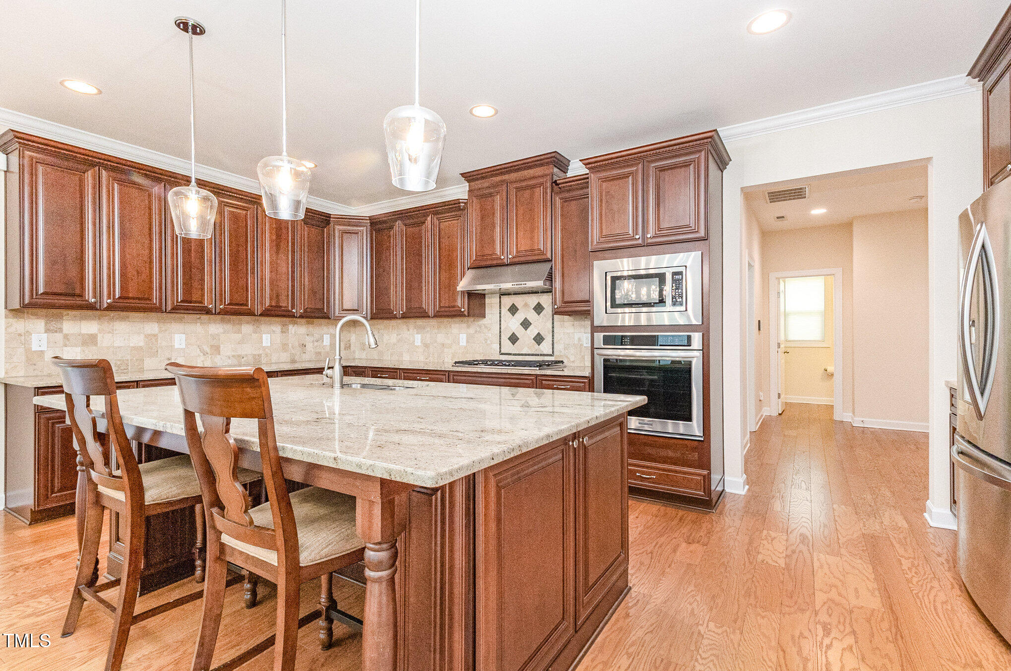 316 Matilda Place Cary, NC 27513 - Photo 12 of 69 a kitchen with stainless steel appliances granite countertop wooden cabinets a stove top oven a sink and dishwasher