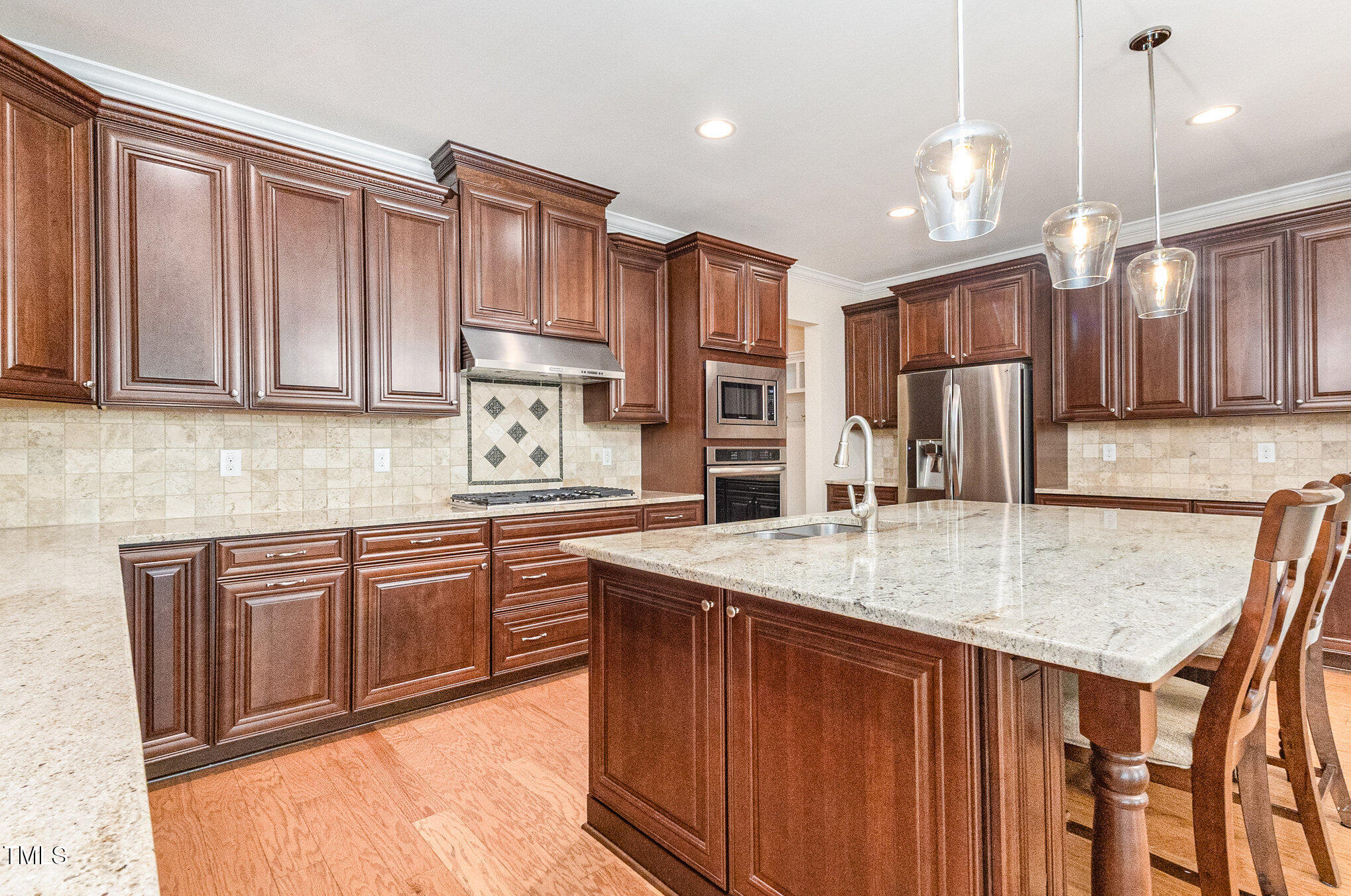 316 Matilda Place Cary, NC 27513 - Photo 14 of 69 a kitchen with stainless steel appliances granite countertop a sink dishwasher a refrigerator and wooden cabinets with wooden floor