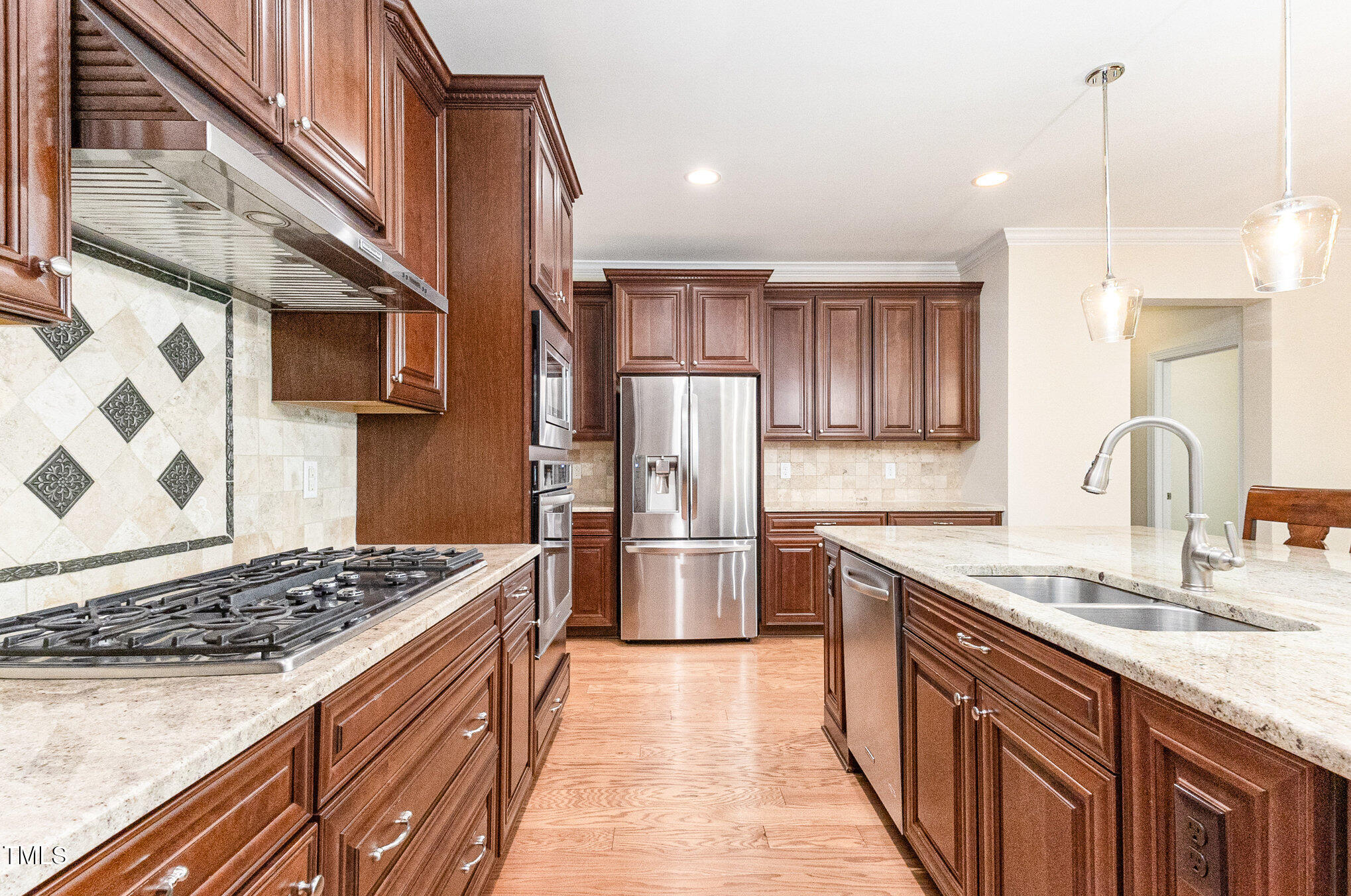 316 Matilda Place Cary, NC 27513 - Photo 16 of 69 a kitchen with stainless steel appliances granite countertop a sink stove and refrigerator