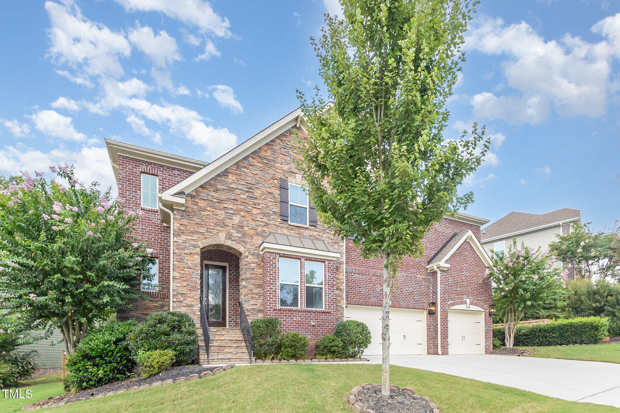 316 Matilda Place Cary, NC 27513 - Photo 2 of 69 a front view of a house with a garden