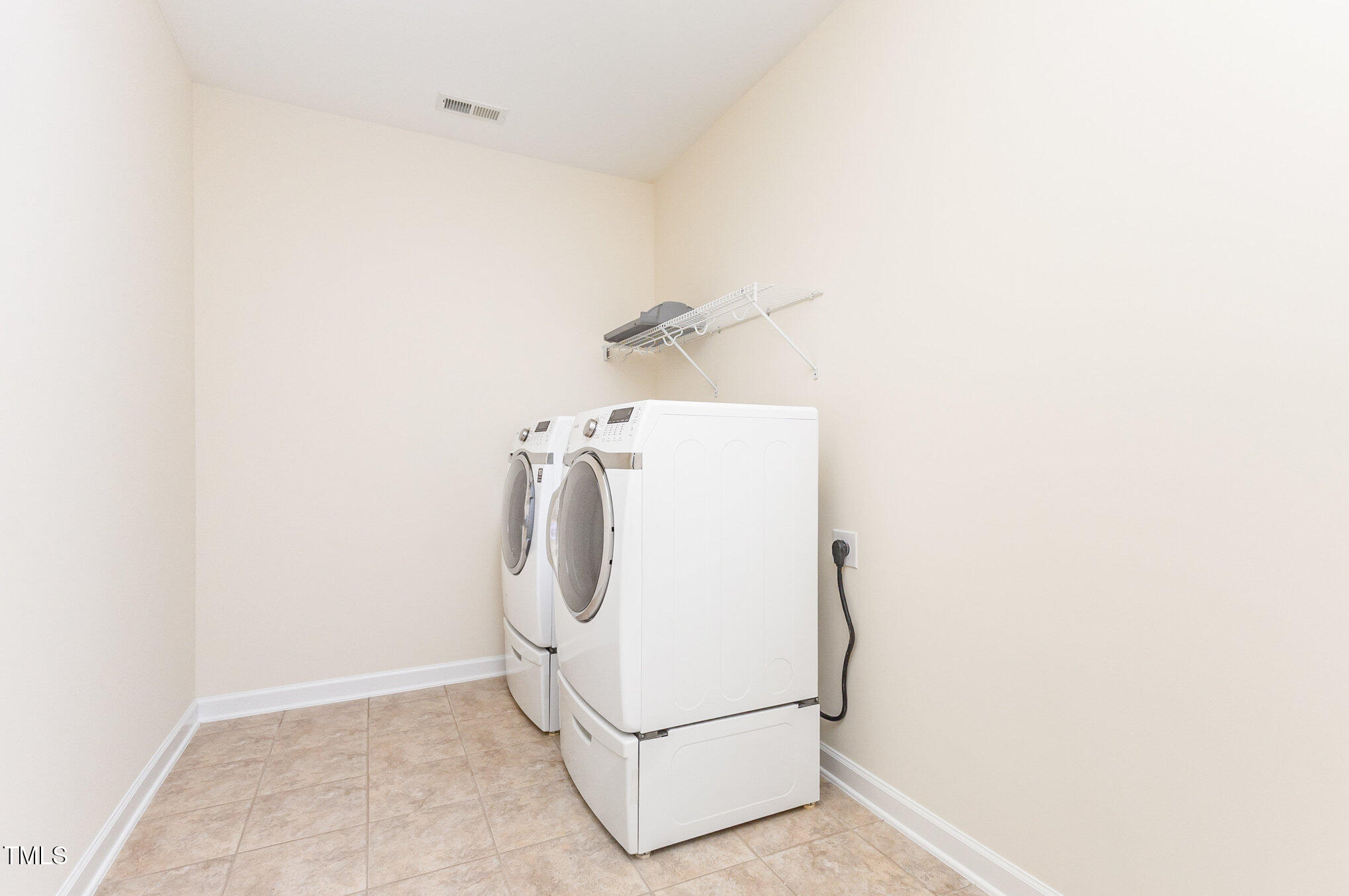 316 Matilda Place Cary, NC 27513 - Photo 46 of 69 a utility room with dryer and washer