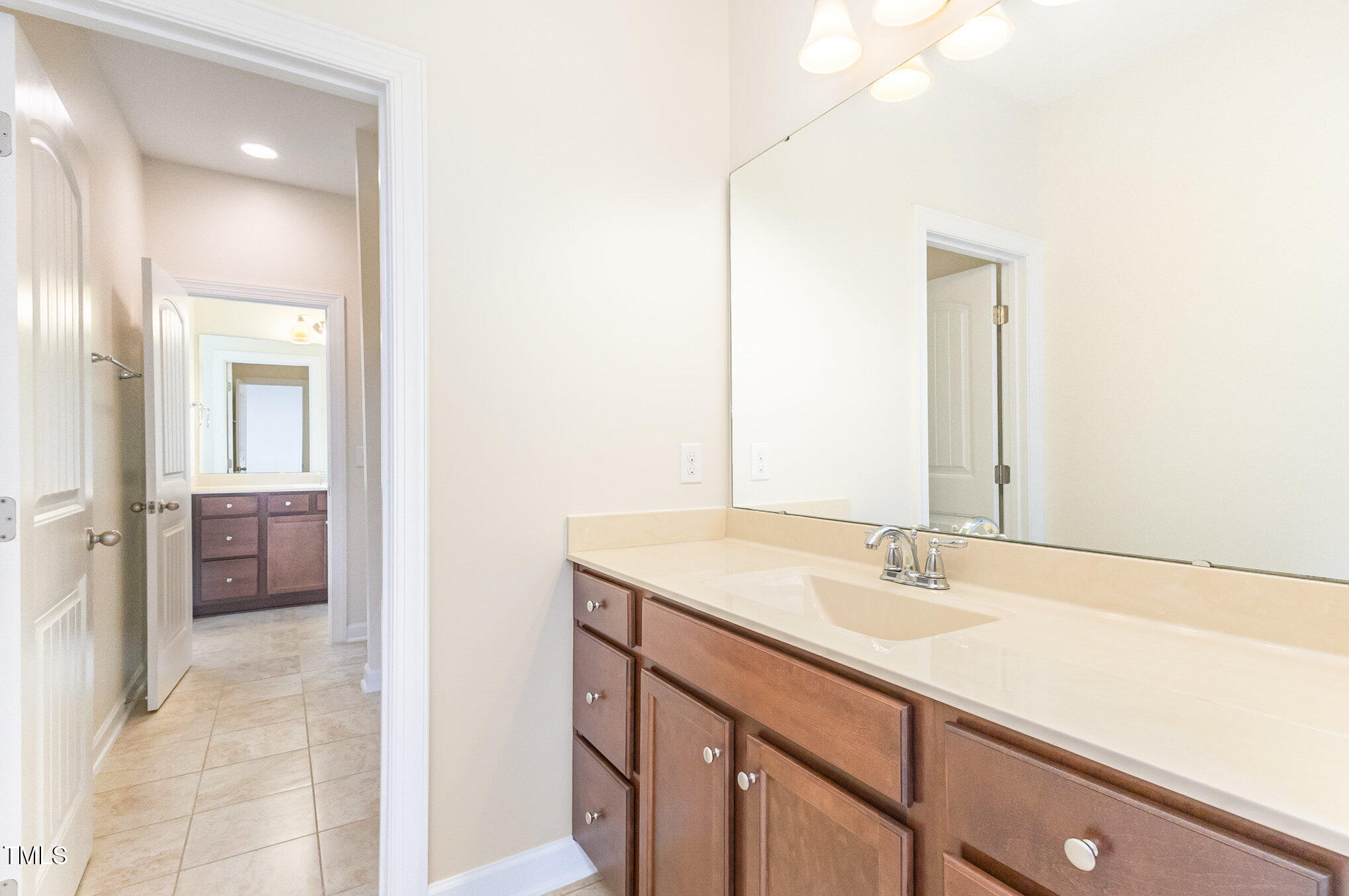 316 Matilda Place Cary, NC 27513 - Photo 52 of 69 a bathroom with a sink a mirror and a shower