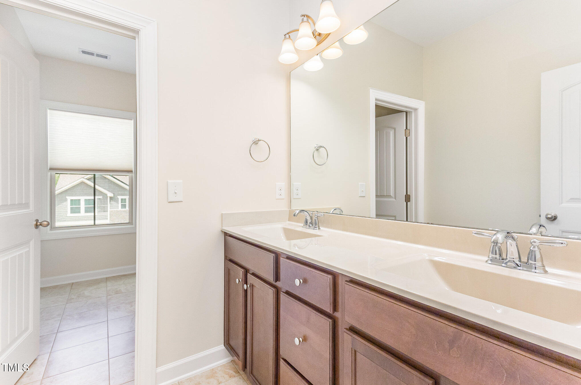316 Matilda Place Cary, NC 27513 - Photo 57 of 69 a bathroom with a sink a vanity and a mirror