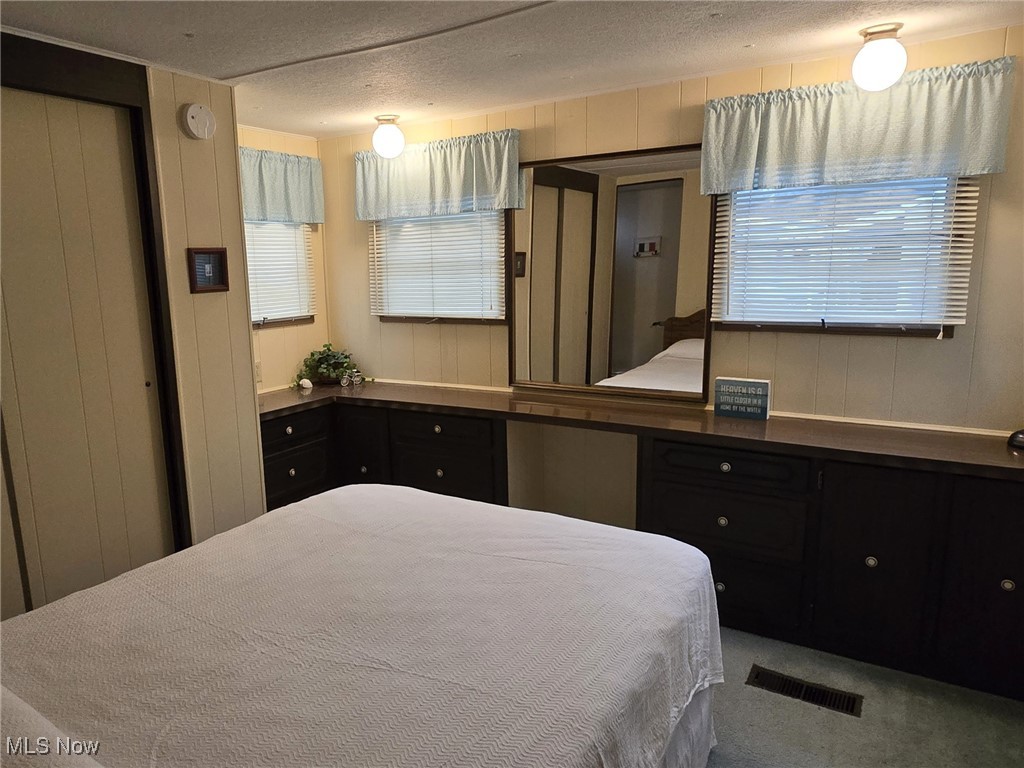 3575 Northeast Catawba Road, Unit 11 Port Clinton, OH 43452 - Photo 16 of 23 Bedroom featuring built in cabinets, wall mirror and closet