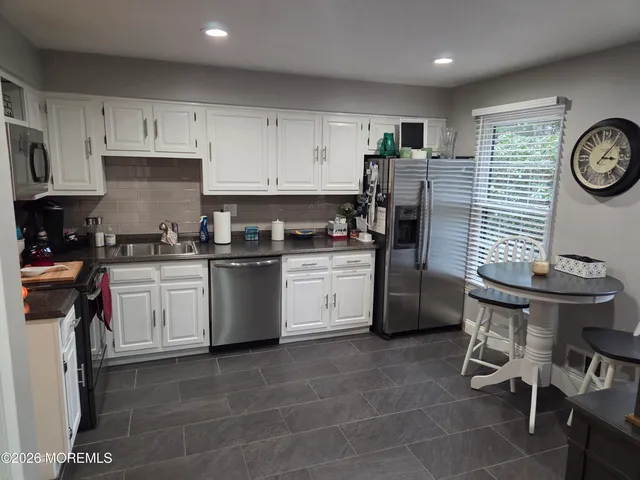 a kitchen with a white cabinets and white appliances