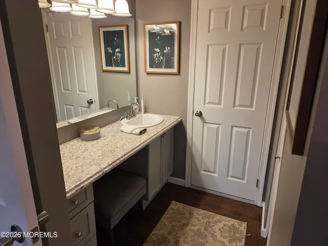 a bathroom with a granite countertop sink and a mirror