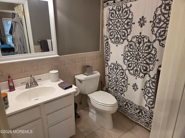 a bathroom with a sink toilet and mirror