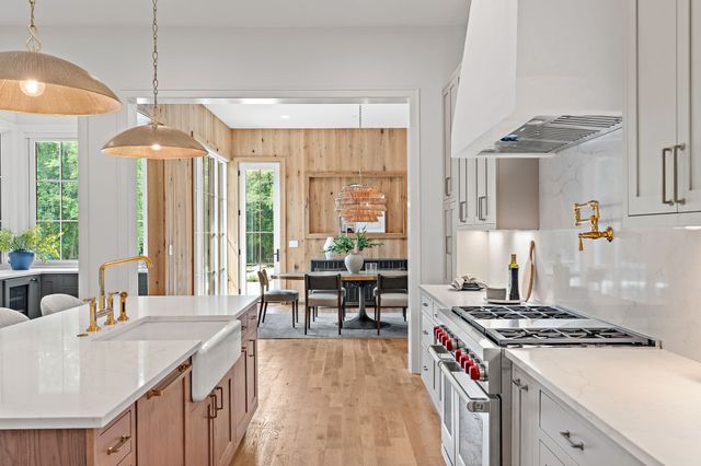 a bedroom with a bed couch and large windows