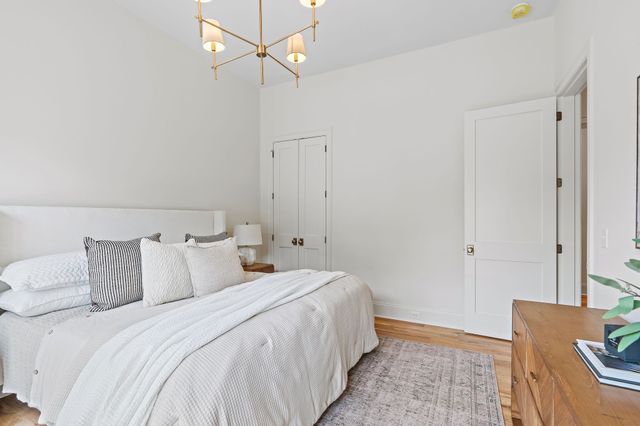 a view of a room with wooden floor closet and windows