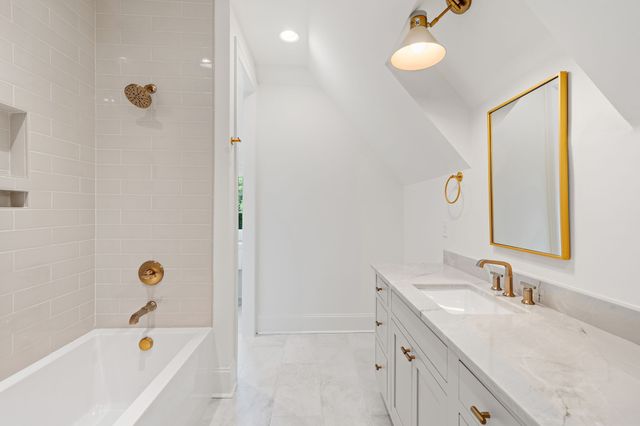 a kitchen with stainless steel appliances a stove a sink and a microwave