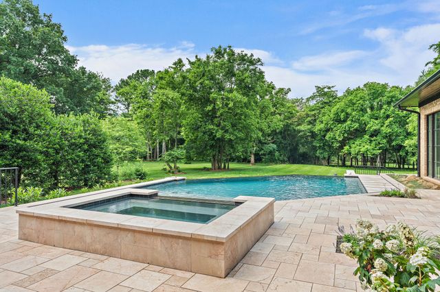 a view of swimming pool with a yard