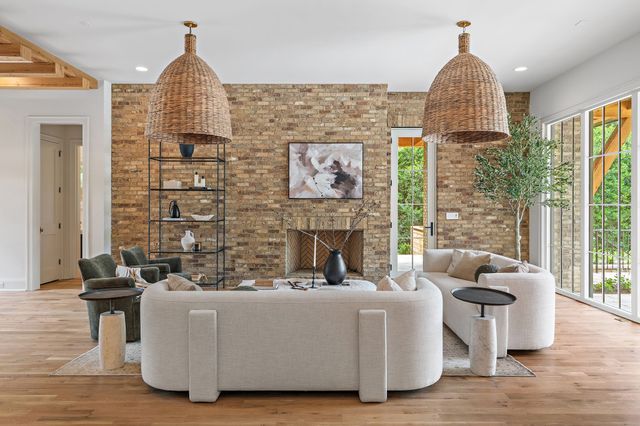 a living room with furniture a couch and a large window