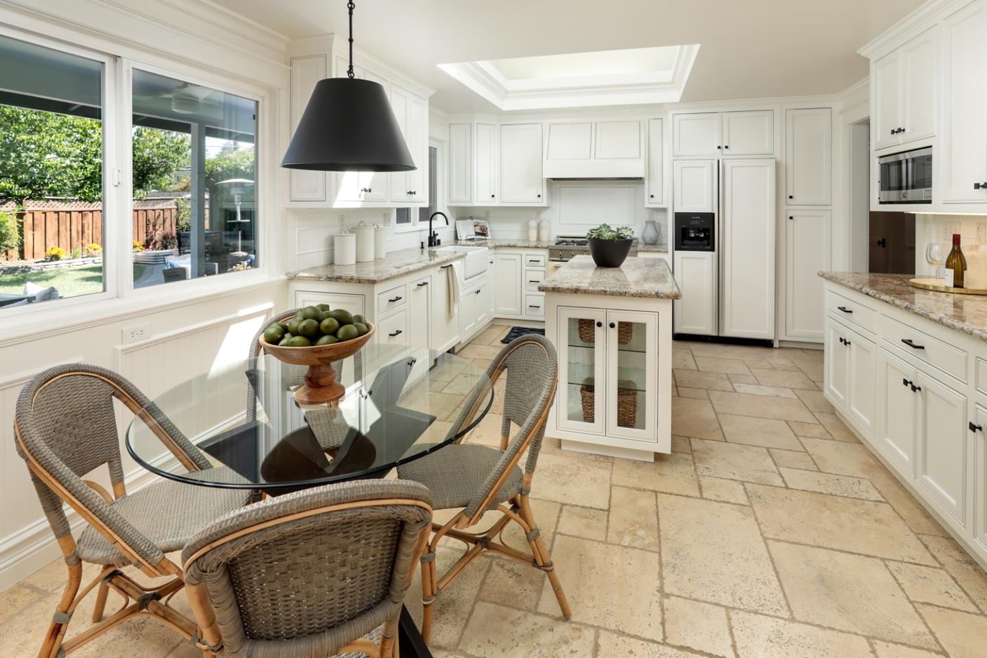 970 Gest Drive Mountain View, CA 94040 - Photo 15 of 53 a kitchen with stainless steel appliances kitchen island granite countertop a table chairs sink and cabinets