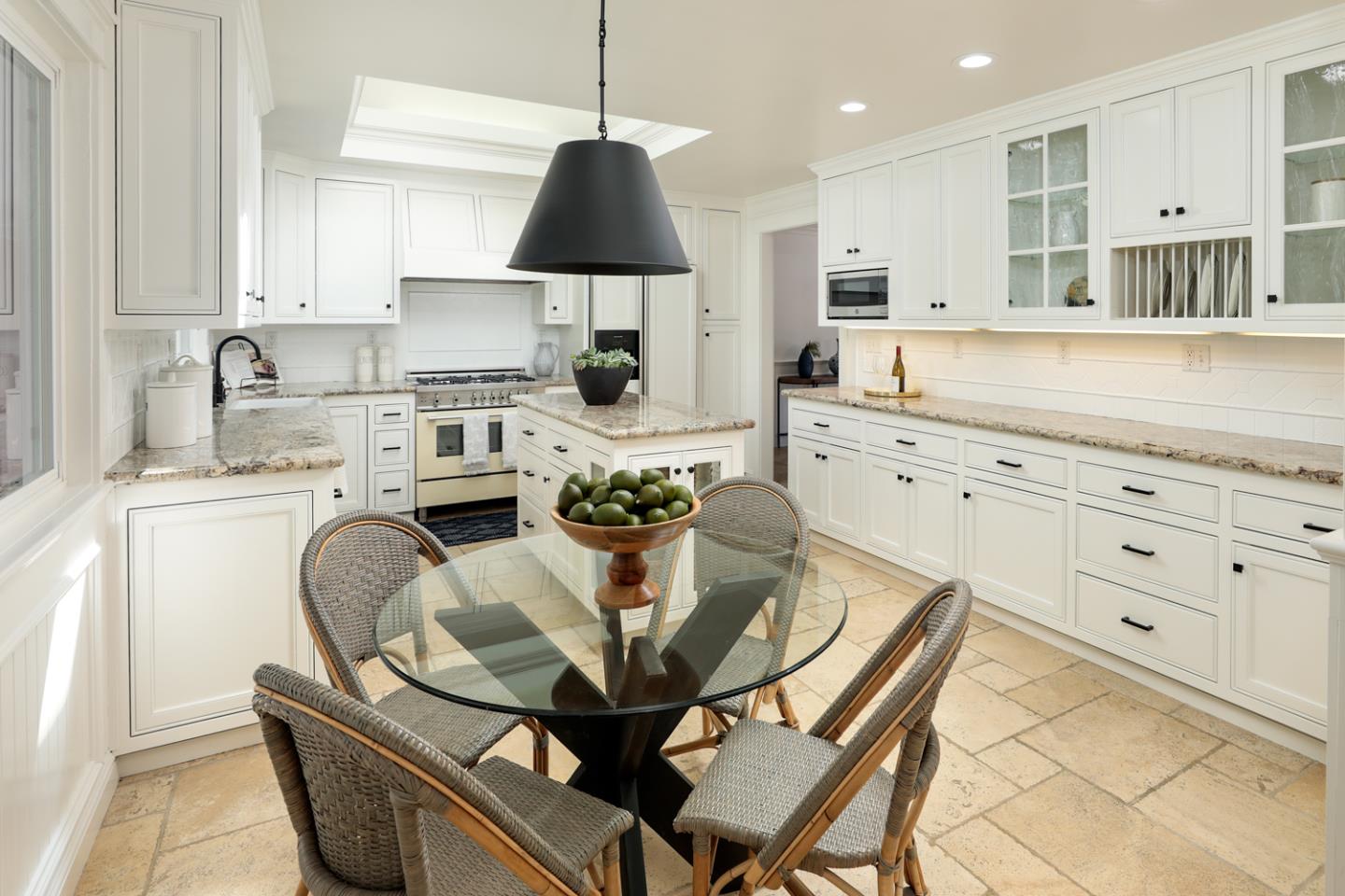 970 Gest Drive Mountain View, CA 94040 - Photo 17 of 53 a kitchen with granite countertop a sink a stove a dining table and chairs