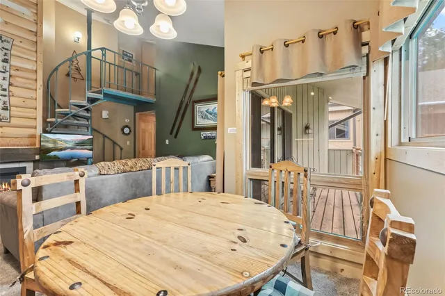 a bedroom with a bed a dresser and large mirror with wooden floor