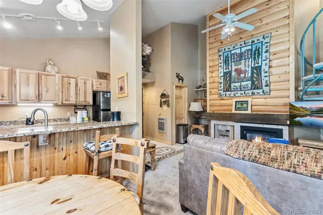a living room with stainless steel appliances kitchen island granite countertop furniture and a large window