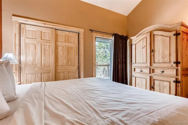 a bedroom with a large bed and a window