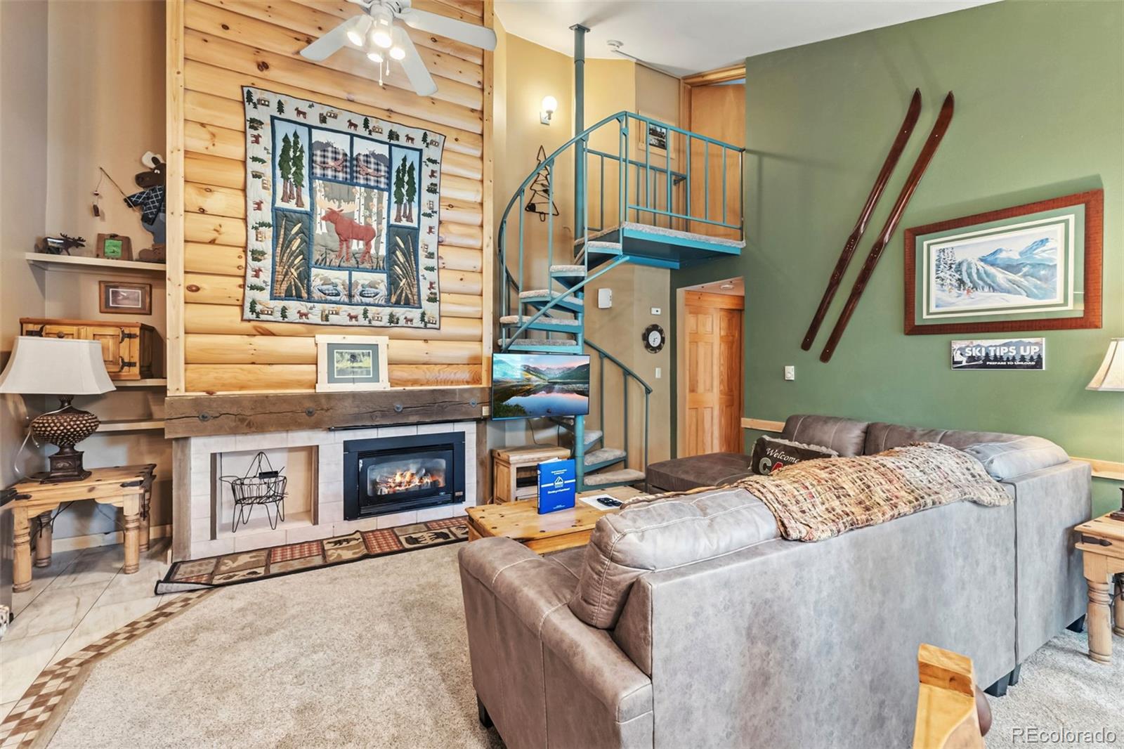 1937 Soda Ridge Road, Unit 1126 Dillon, CO 80435 - Photo 5 of 42 a living room with furniture a fireplace and a flat screen tv