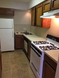 a kitchen with a stove and a refrigerator