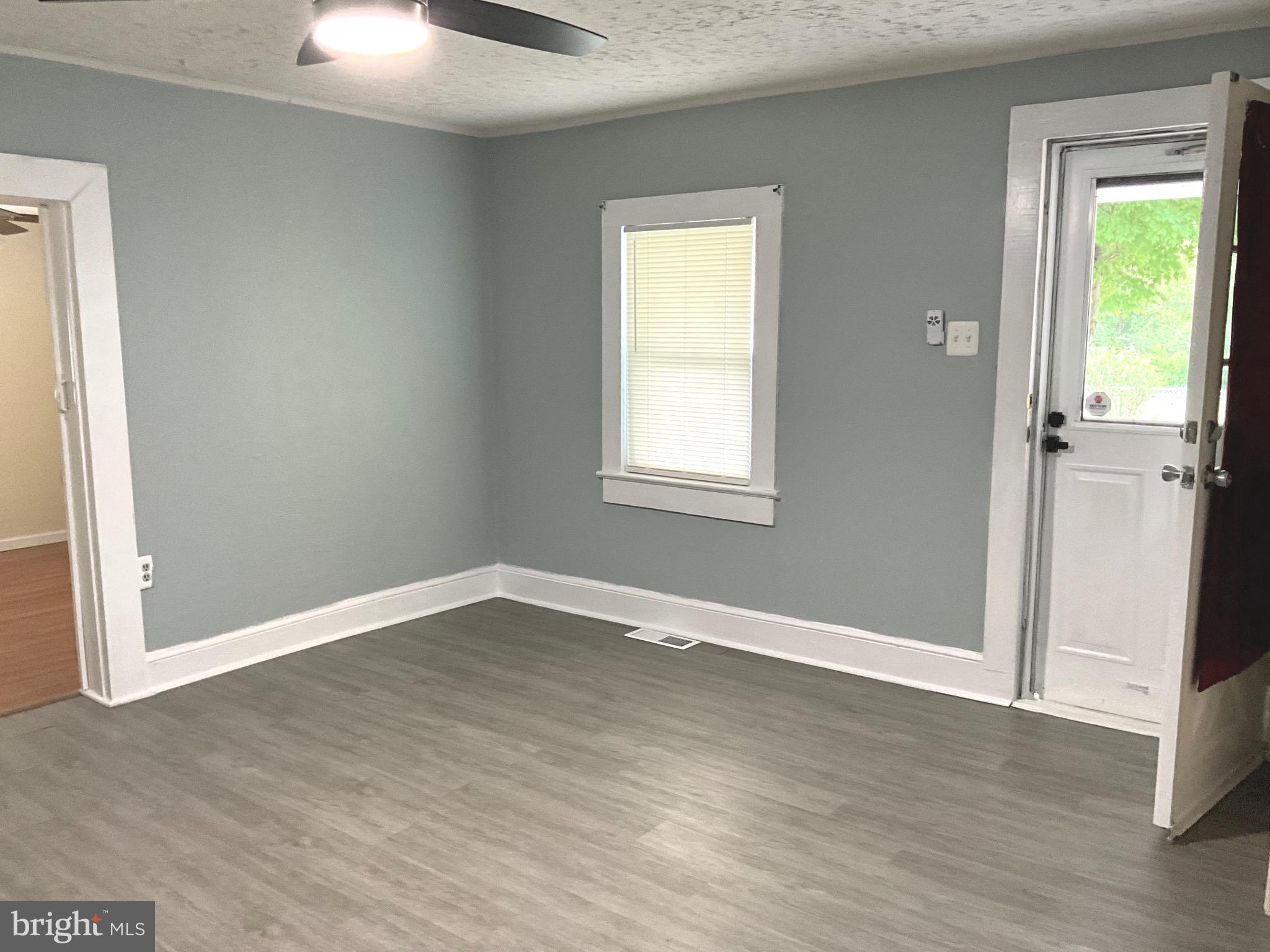 86 Kelley Road Fredericksburg, VA 22405 - Photo 3 of 36 an empty room with wooden floor cabinet and windows