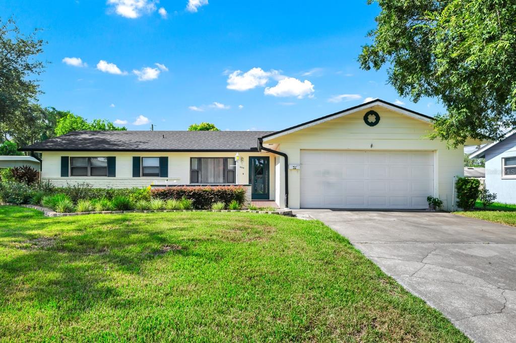 4538 Gilpin Way Orlando, FL 32812 - Photo 1 of 1 a front view of a house with a yard and garage
