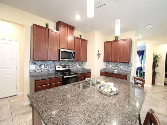 a living room with furniture gym equipment and a chandelier