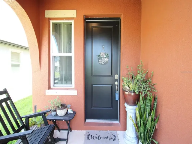 a dining room with wooden floor a chandelier a wooden table and chairs