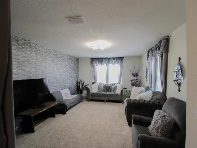 a spacious bedroom with a bed and a chandelier