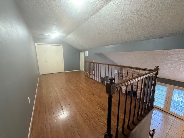 22122 Diane Drive Spring, TX 77373 - Photo 10 of 13 a view of a hallway with wooden floor and stairs