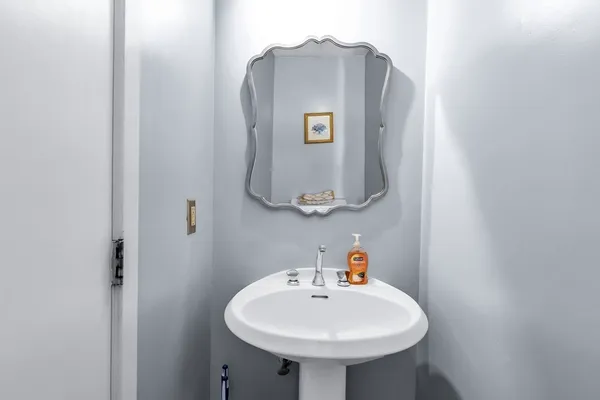 a bathroom with a sink and mirror