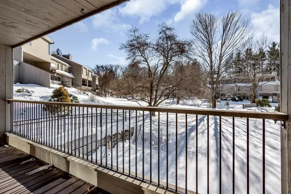 a view of balcony with wooden floor