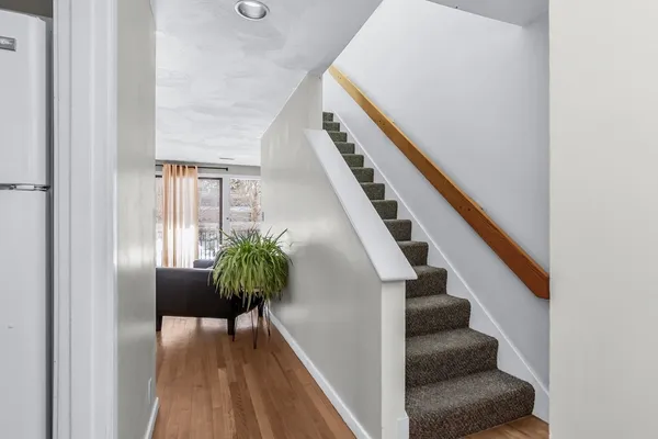 a view of entryway and hall with wooden floor
