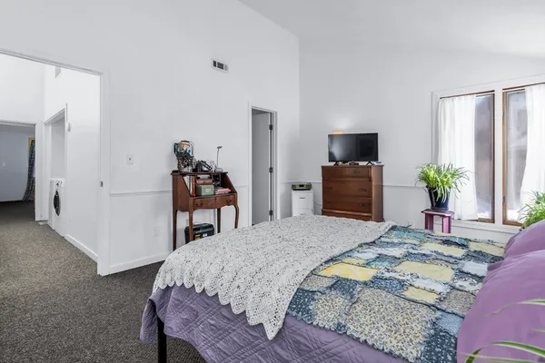 a bedroom with a bed and a dresser