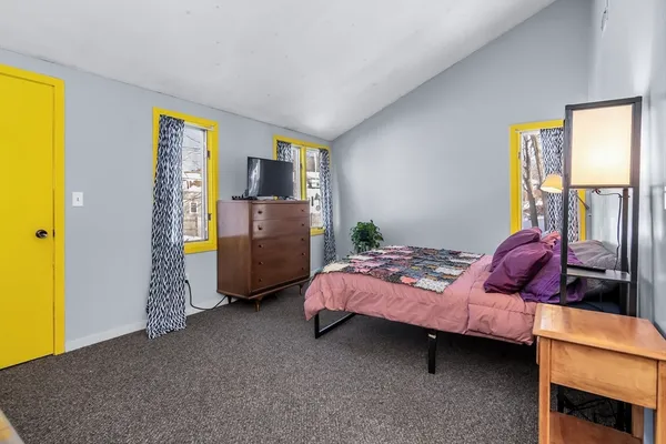 a bed room with a bed and a window