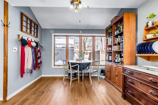 a view of a dining room with furniture window and wooden floor