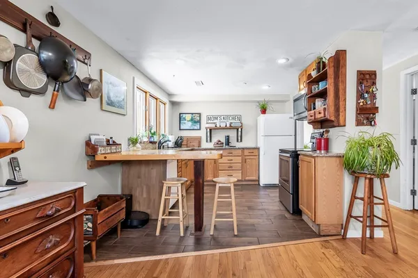 a dining room with stainless steel appliances kitchen island granite countertop furniture and a kitchen view