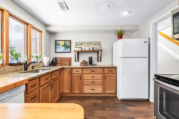 a kitchen with stainless steel appliances a refrigerator sink and cabinets