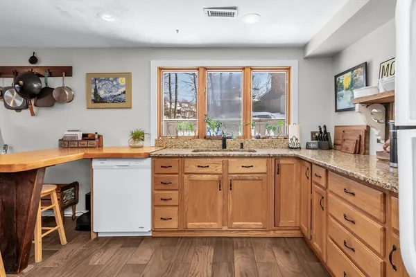 a kitchen with stainless steel appliances granite countertop a stove a sink and a refrigerator