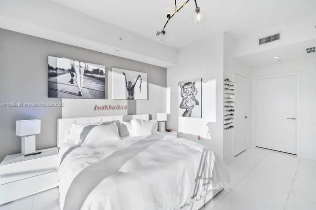 a bedroom with a large bed and a window