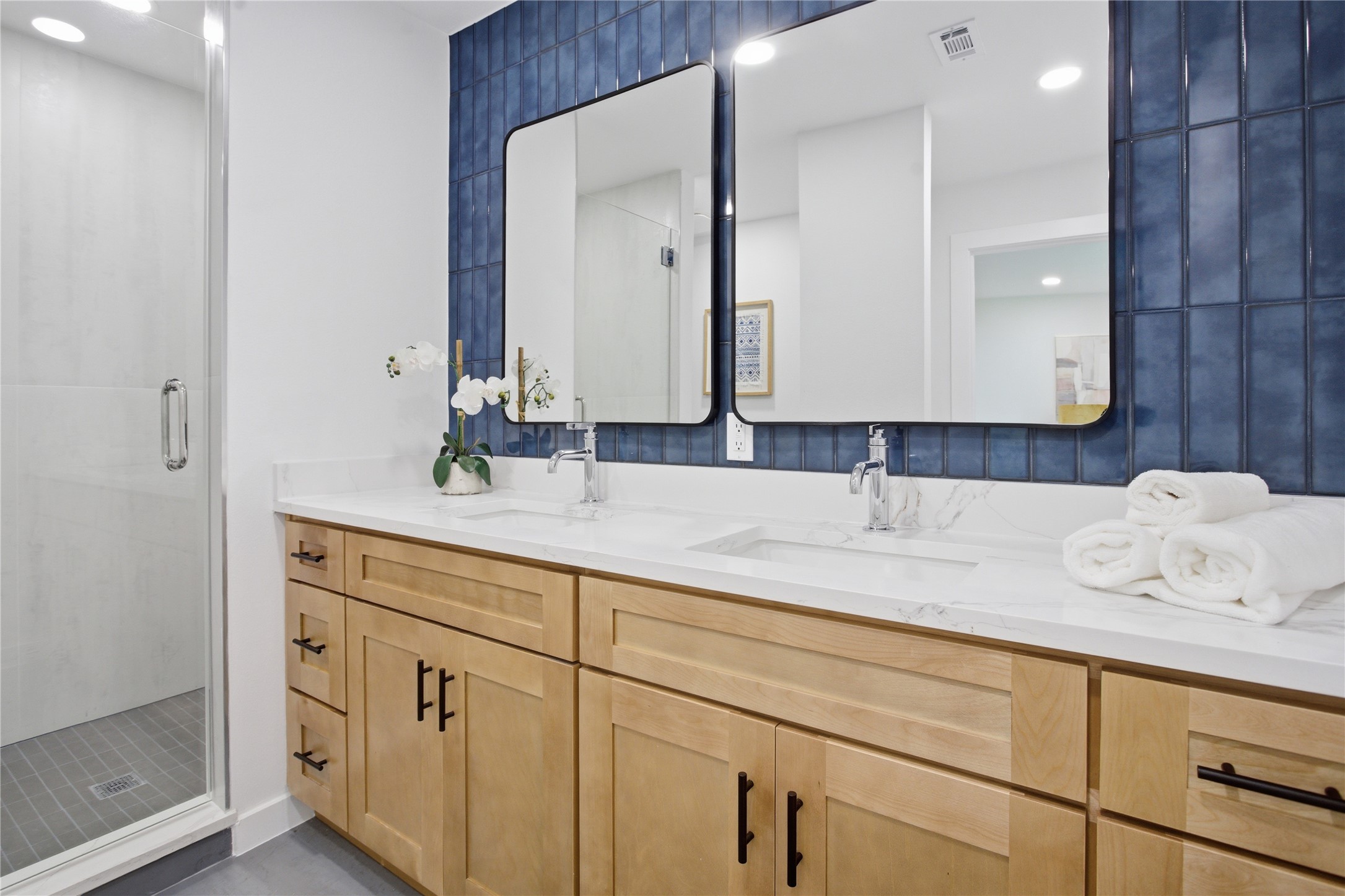 2110 Magazine Street Austin, TX 78727 - Photo 25 of 31 Elegant primary bathroom with dual vanity, light wood cabinetry, white countertops, and chrome fixtures