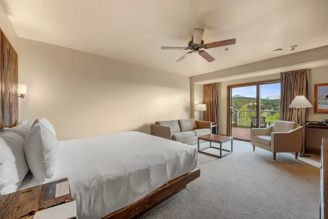 a bedroom with a bed patio couch and a large window