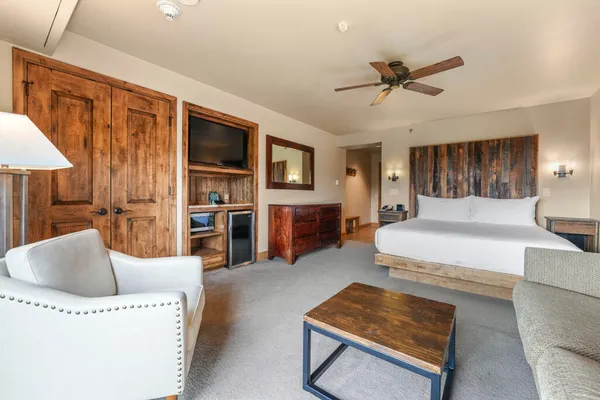 a living room with furniture and a ceiling fan