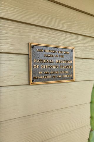a living room with furniture a rug and a flat screen tv