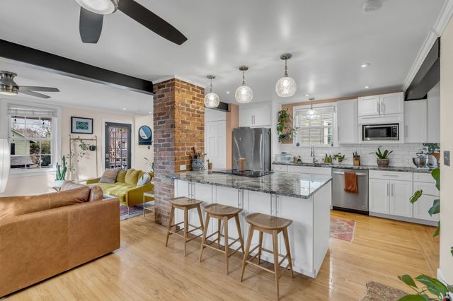 a bathroom with a tub sink a mirror and shower
