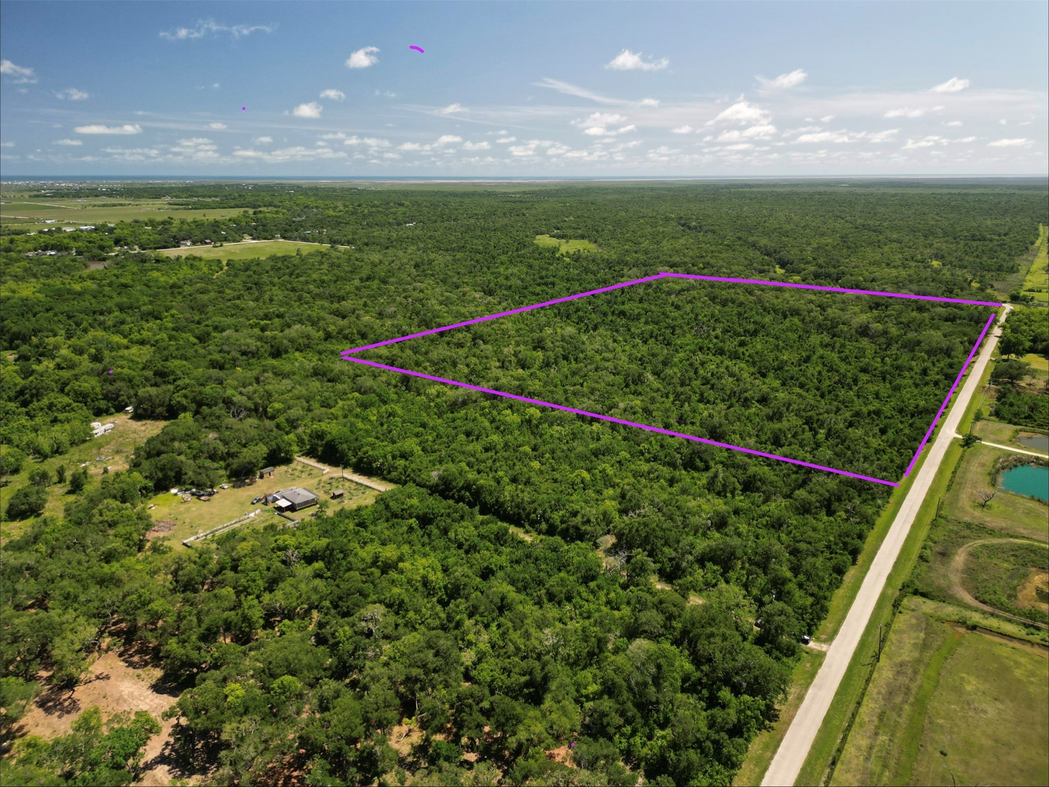 281 Rd Sargent Tx 77414 Road Sargent, TX 77414 - Photo 3 of 23 a view of a garden from a balcony